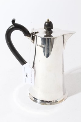Lot 28 - George V Silver hot water pot of tapered form with flared foot, body engraved Marjory, with ebony handle and finial (Sheffield 1923), maker, Sutherland & Roden, all at 12.5oz, 16.5cm in height