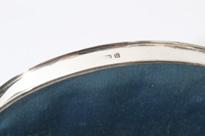 Lot 19 - George V Silver ring / jewellery box of crescent form with hinged lid, opening to reveal fitted silk and velvet lined interior, raised on four feet, (Birmingham 1919) 14.2cm in length