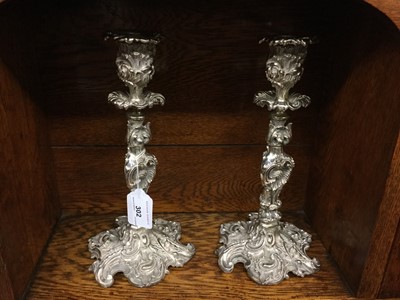 Lot 302 - Pair of ornate Victorian silver plated candlesticks with scroll decoration