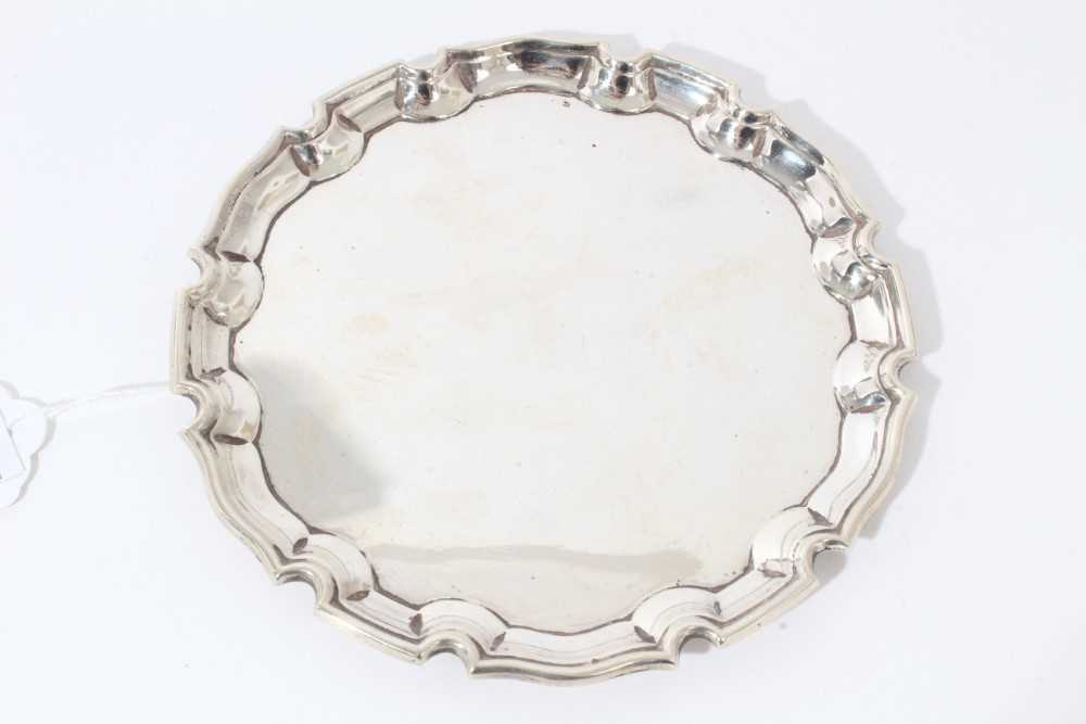 Lot 5 - George V silver card tray of circular form with pie crust border, (Birmingham 1932), maker Cohen & Charles, all at 4oz, 15.5cm in diameter
