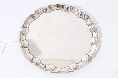Lot 5 - George V silver card tray of circular form with pie crust border, (Birmingham 1932), maker Cohen & Charles, all at 4oz, 15.5cm in diameter