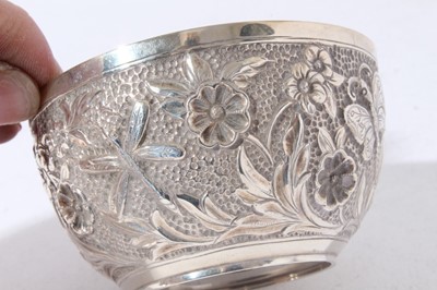Lot 57 - Good quality Victorian silver cream jug with chased decoration depicting flowers and insects together with a matching sugar bowl, (Birmingham 1894), maker William Harrison Walter, all at 3.5oz (2)