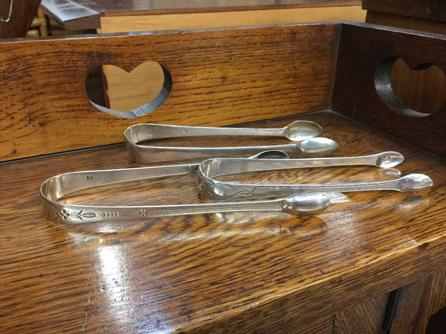 Lot 719 - Three pairs of Georgian silver sugar tongs