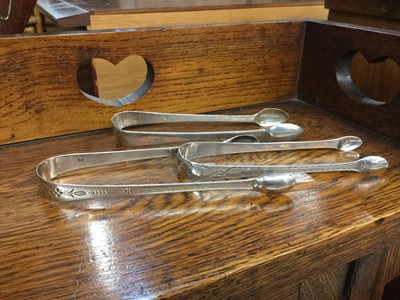 Lot 719 - Three pairs of Georgian silver sugar tongs