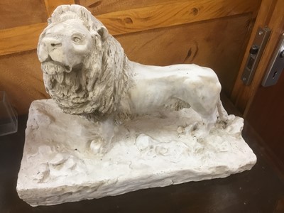 Lot 211 - Plaster sculpture of a lion, on naturalistic base, 46cm long