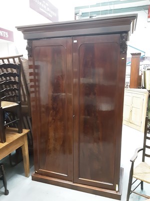 Lot 1105 - Good quality Victorian mahogany double wardrobe enclosed by two arched panelled doors