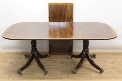 Lot 741 - Regency and later mahogany and crossbanded twin pillar dining table in the Irish style