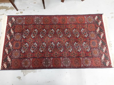 Lot 1113 - Eastern rug with geometric decoration on red ground, 157cm x 86cm