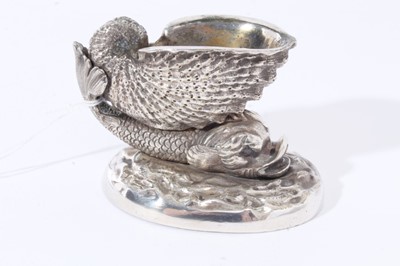 Lot 13 - Pair of 19th century cast white metal salts  in the form of a nautilus shell on the back of a dolphin, on a wave pattern oval base, possibly an Elkington electrotype, 9.5cm overall width