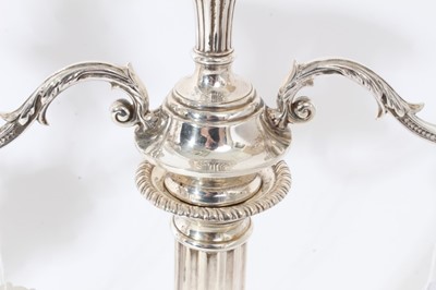Lot 114 - Pair of George VI silver candelabra, each with fluted columns and gadrooned borders, removable twin branches and three candle holders with removable sconces (Birmingham 1937)