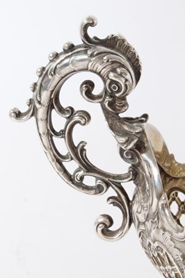 Lot 178 - Edwardian silver table centre of oval form with embossed and pierced decoration with twin handles modelled as classical Dolphins, raised on and oval foot with four scroll feet, (London 1901)