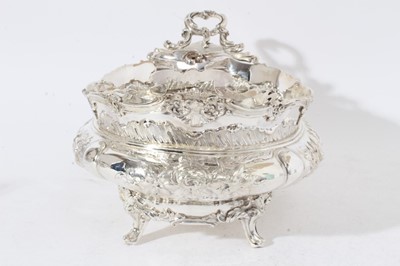 Lot 225 - Impressive Edwardian silver table centre bowl of oval form with embossed floral and scroll decoration twin scroll handles and raised on four scroll feet, (London 1901)