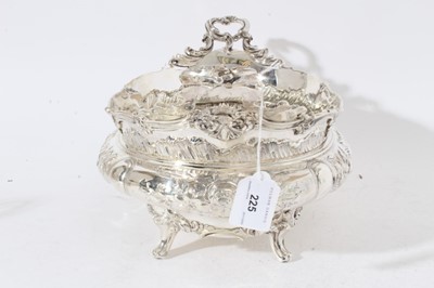 Lot 225 - Impressive Edwardian silver table centre bowl of oval form with embossed floral and scroll decoration twin scroll handles and raised on four scroll feet, (London 1901)