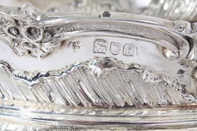 Lot 225 - Impressive Edwardian silver table centre bowl of oval form with embossed floral and scroll decoration twin scroll handles and raised on four scroll feet, (London 1901)