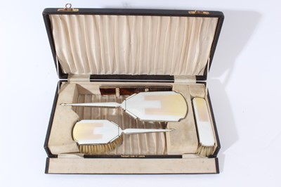 Lot 79 - 1930s Art Deco silver and guilloché enamel mounted ladies vanity set, comprising hand mirror and two brushes, (Birmingham 1936), maker Charles S Green & Co Ltd.