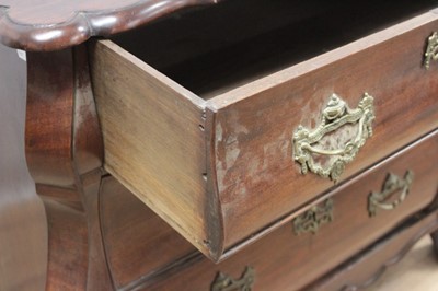 Lot 1307 - 19th century Dutch mahogany bombe commode chest, the shaped top above three long graduated drawers with brass handles and escutcheons, on carved claw and ball feet, 110cm at the widest point x 60cm...