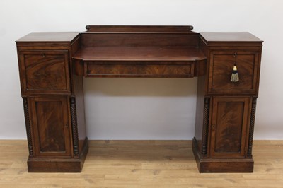 Lot 1463 - Regency mahogany twin pedestal sunk centre sideboard, each pedestal with panelled cupboard doors flanked by carved twisted columns, a single lead lined drawer to the right pedestal, 165cm wide x 50...