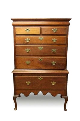 Lot 1460 - George I solid walnut chest on stand, the moulded cornice above a frieze drawer, two short and three long graduated drawers and a single deep drawer to the stand, each with brass swan neck handles...