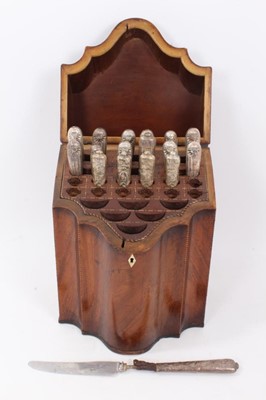 Lot 277 - George III mahogany knife box with serpentine front, barber pole stringing and fitted interior, containing an assortment of seventeen silver and white metal handled knives, 24cm wide x 35.5cm high