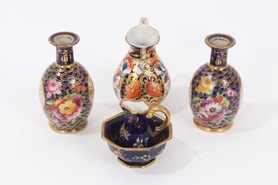 Lot 69 - Selection of early 19th century miniature English porcelain, including a Spode jug and basin, a Crown Derby jug, and a pair of floral painted bottle vases (5), the largest measuring 8.75cm height