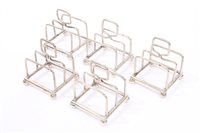 Lot 527 - Five 1920s silver individual toast racks of...