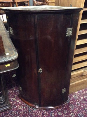 Lot 1032 - George III mahogany bow front hanging corner cupboard enclosed by two doors