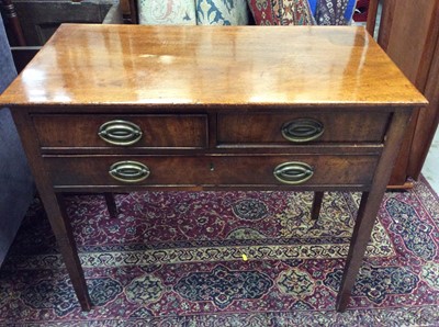 Lot 988 - George III mahogany side table with two short and one long drawer with original oval brass ring handles on square taper legs