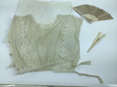 Lot 1755 - An Edwardian sleeveless cropped lace blouse, small lace collars and cuffs, lace lengths, a quantity of lace mats in a circular embroidered folder, small framed silk portrait, lace christening dress...