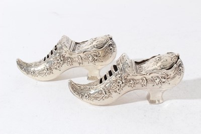Lot 161 - Pair of late Victorian Continental silver Pot Pouri holders in the form of shoes with embossed decoration, hinged covers and gilded interiors with import marks (London 1900)