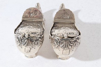 Lot 161 - Pair of late Victorian Continental silver Pot Pouri holders in the form of shoes with embossed decoration, hinged covers and gilded interiors with import marks (London 1900)