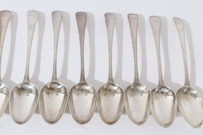 Lot 160 - Set of twelve Georgian silver Old English pattern feather edge table spoons (London 1778) together with eleven matching dessert spoons, (marks rubbed)