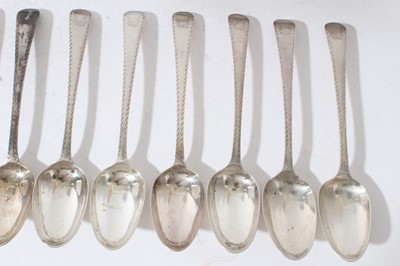Lot 160 - Set of twelve Georgian silver Old English pattern feather edge table spoons (London 1778) together with eleven matching dessert spoons, (marks rubbed)