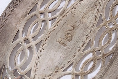 Lot 158 - George III silver fish slice with curved pierced blade and brite cut engraved decoration (London 1800), together with another similar (London 1787), 31 and 30cm in length (2)