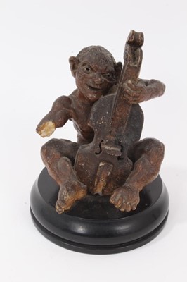 Lot 12 - Martin Brothers salt glazed pottery sculpture of a grotesque figure playing a cello