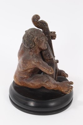 Lot 12 - Martin Brothers salt glazed pottery sculpture of a grotesque figure playing a cello