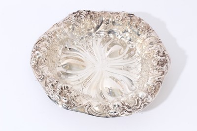 Lot 125 - American silver dish of shaped circular form with embossed floral decoration, maker Gorham & Co, stamped Sterling and numbered A5626, all at approximately 10oz, approx, 26cm in diameter.