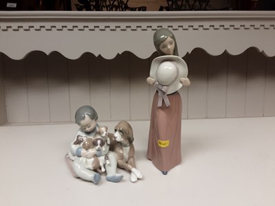 Lot 180 - Lladro porcelain figure group of a child with dog and puppies, one other LLadro figure and two similar figures