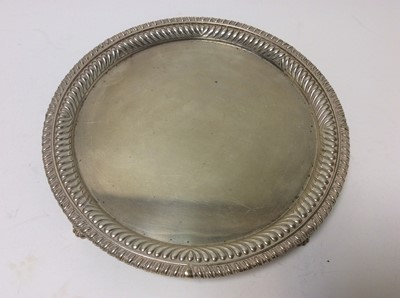 Lot 233 - Victorian silver salver of circular form with fluted decoration and gadrooned borders, raised on four scroll and claw feet, (London 1885), maker Charles Frederick Hancock