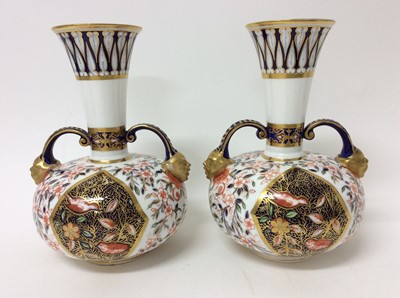 Lot 203 - Pair of Royal Crown Derby Imari pattern bottle vases, twin-handled with mask terminals, 19.75cm height