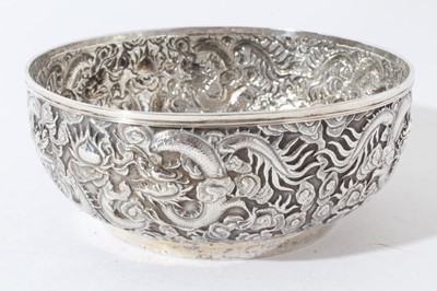 Lot 39 - Good quality late 19th century Chinese Export silver bowl with embossed decoration depicting Dragons amongst clouds, marks to base for Wang Hing