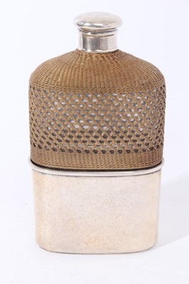 Lot 86 - Victorian silver mounted glass hip flask with silver screw fit top, (London 1868) wicker covered body and silver plated detachable cup with gilded interior, 15.5cm in length