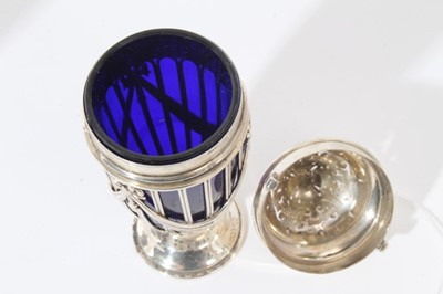 Lot 112 - Edwardian silver sugar caster of tapered cylindrical form, wire frame body with ribbons and swags and blue glass liner, pierced cover with bayonet fitting, on circular foot, (London 1902)