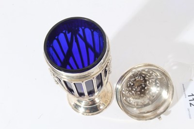Lot 112 - Edwardian silver sugar caster of tapered cylindrical form, wire frame body with ribbons and swags and blue glass liner, pierced cover with bayonet fitting, on circular foot, (London 1902)