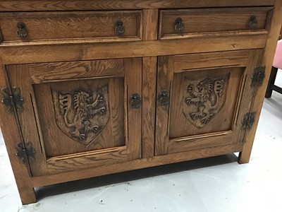 Lot 195 - Good quality carved oak dining room suite comprising refectory table on pierced end standards 211 x 103 cm, eight chairs with tapestry seats, oak sideboard with armorial lion decoration116 cm