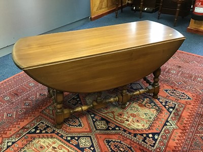 Lot 878 - Ercol elm dropleaf coffee table on turned supports joined by stretchers 107 cm