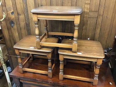 Lot 880 - Set of three Ercol elm occasional tables on turned legs joined by stretchers