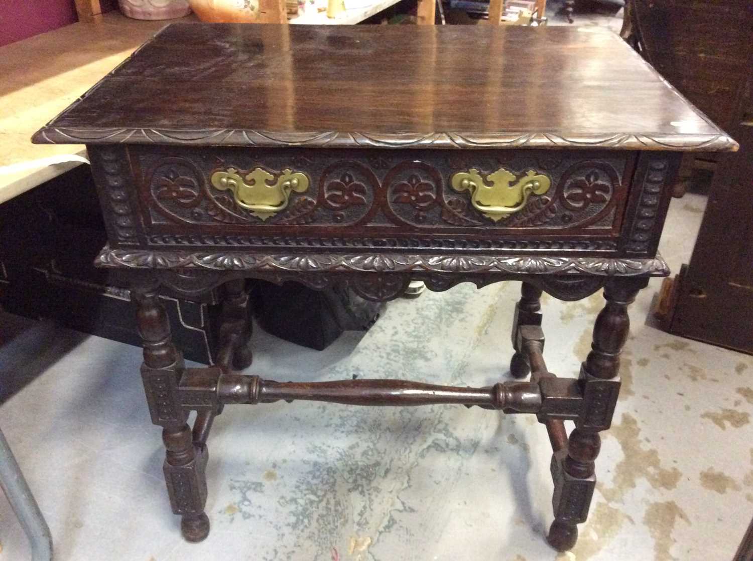 Lot 969 - Carved oak side table with single draw