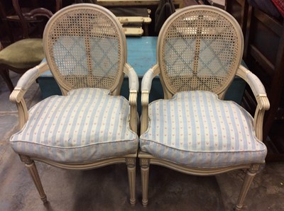 Lot 965 - Pair of painted open armchairs with caned backs and loose cushions in Bernard Thorp fabric, together with an oval stool