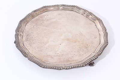 Lot 106 - George VI silver salver with pie crust edge and gadrooned border, raised on three claw and ball feet (Sheffield 1937), maker Cooper Brothers & Sons Ltd, all at approximately 17oz, 26cm in diameter