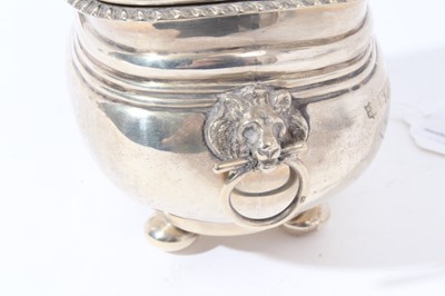 Lot 107 - Edwardian silver tea caddy of oval cauldron form with reeded bands and and engraved armorial, domed hinged cover with gadrooned border, raised on four bun feet, (Chester 1906)